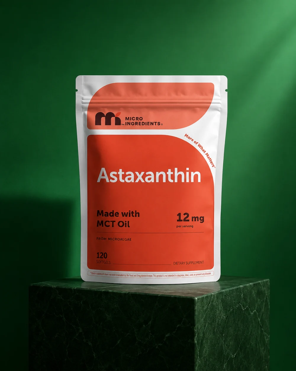 Micro Ingredients Astaxanthin pouch on an emerald studio pedestal