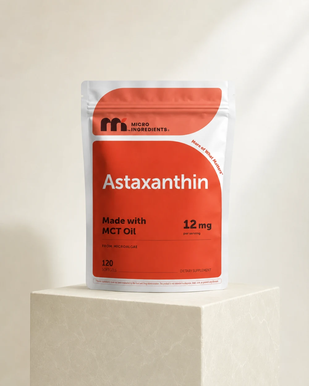 Micro Ingredients Astaxanthin pouch on an ivory studio pedestal